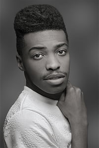 grayscale photography of man holding his neck thumbnail