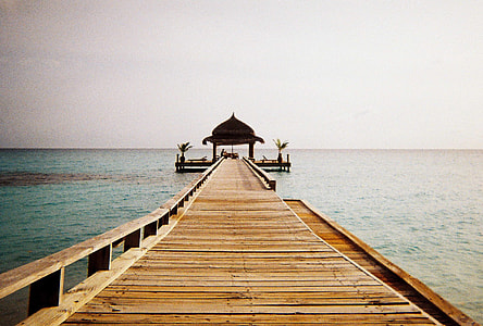 gazebo on brown wooden dock above sea thumbnail