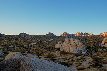 beige rock monument beside grass field thumbnail