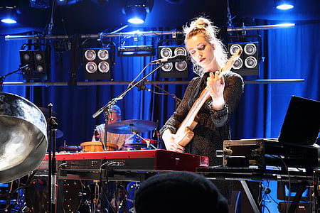 woman holding electric guitar thumbnail