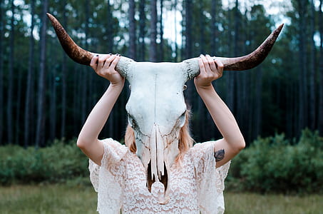 woman raising animal skull thumbnail