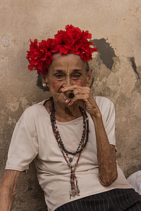 woman wearing white scoop-neck top while using tobacco photo during daytime thumbnail