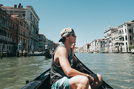 man riding black boat thumbnail