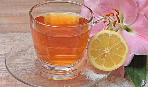 clear glass mug filled with orange liquid thumbnail