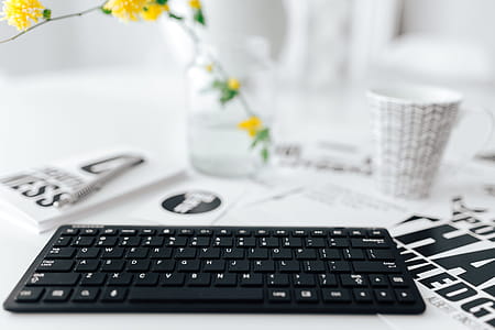 Female hands typing on the remote wireless computer keyboard thumbnail
