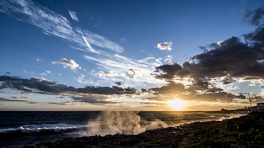 shoreline under cloudy blue sky thumbnail