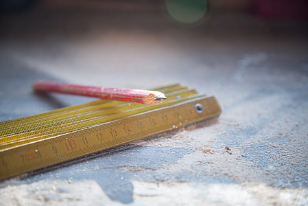 selective focus photography of red pencil on carpenter's ruler thumbnail