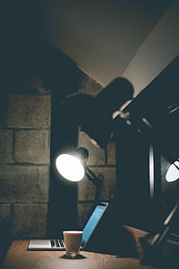 turned on gray desk lamp near gray laptop computer thumbnail