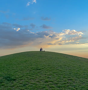 person sitting on top of hills thumbnail