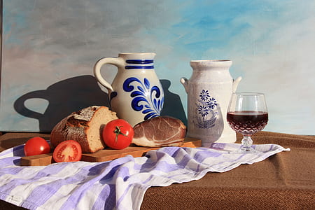 two ceramic pitchers beside bread loaf and tomatoes thumbnail