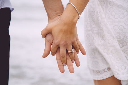 photo of two person holding each other's hands thumbnail