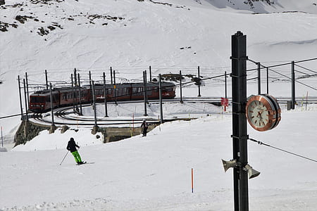 man playing snow skis near train railway thumbnail