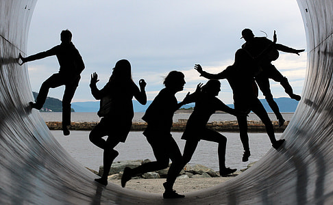silhouette of people sliding on tunnel during daytime thumbnail