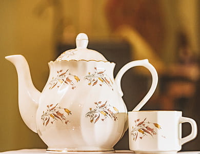 white and brown ceramic teapot beside teacup thumbnail