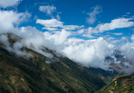 mountain cover with trees and white clouds photography thumbnail