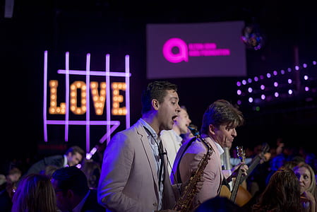 person in brown coat playing saxophone thumbnail