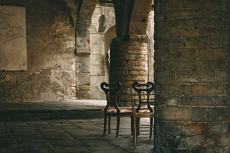 brown armless chairs inside a brown building thumbnail