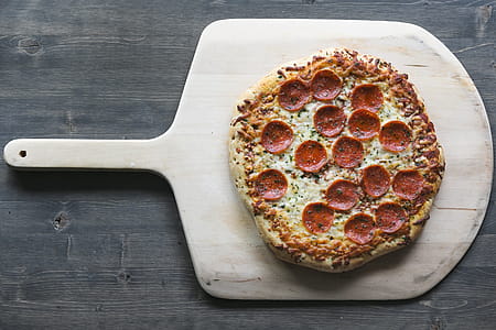 Pepperoni Pizza On Wood Board Photo thumbnail