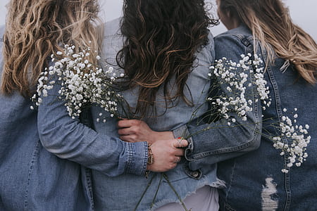 three woman wearing denim jackets thumbnail