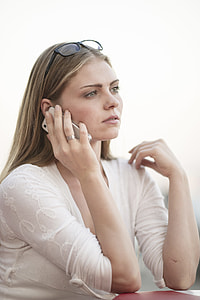 woman sitting on chair while taking a calls thumbnail
