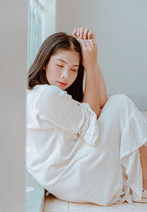 Woman Sitting Wearing White Dress thumbnail