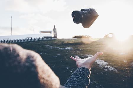 person tossing DSLR camera thumbnail