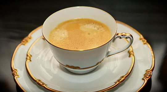 coffee in white ceramic cup with saucer thumbnail