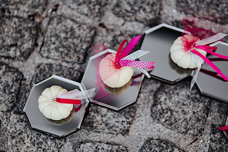 Decorative white pumpkin trinkets with ribbons on the floor thumbnail