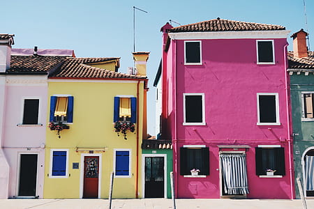 purple concrete house beside yellow house thumbnail