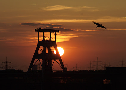 silhouette of mill and eagle gliding thumbnail