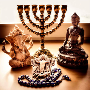 gold-colored candelabra and two Buddha and Ganesha figurines thumbnail