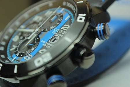 close-up of round black chronograph watch thumbnail