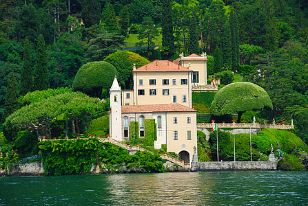 beige and white house near body of water thumbnail