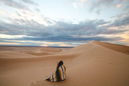 person covering with scarf at dessert thumbnail