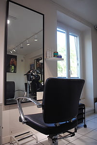 black leather salon chair in front of mirror thumbnail