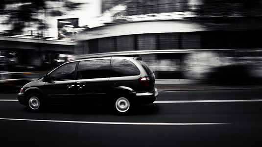 black mini-van on road thumbnail