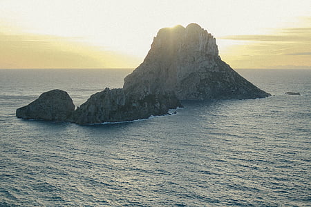 gray mountain surrounded by body of water thumbnail