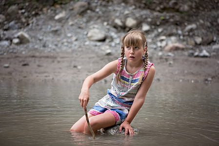 girl sitting on rock in water thumbnail