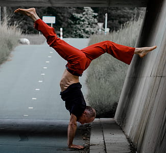 selective color of man doing stunts near wall on roadway thumbnail