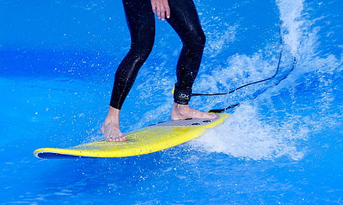 person surfing on yellow surfboard thumbnail