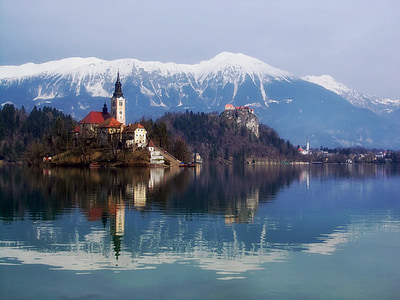 village near body of water painting thumbnail