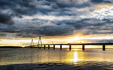 photo of bridge under dark clouds thumbnail