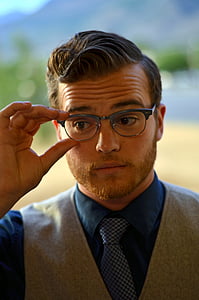 man wearing eyeglasses and gray vest thumbnail