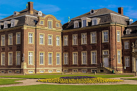 brown brick building near grass field thumbnail