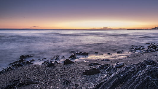 gray rock lot in front of ocean thumbnail