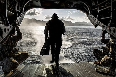 soldier on craft in front of body of water thumbnail