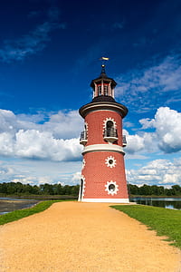 red tower near grass field thumbnail