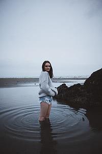 woman in gray jacket on body of water thumbnail