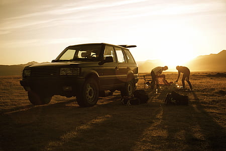 two person beside vehicle near mountain thumbnail