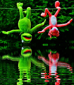kermit the frog and pink panther plush toys hanging on wire thumbnail